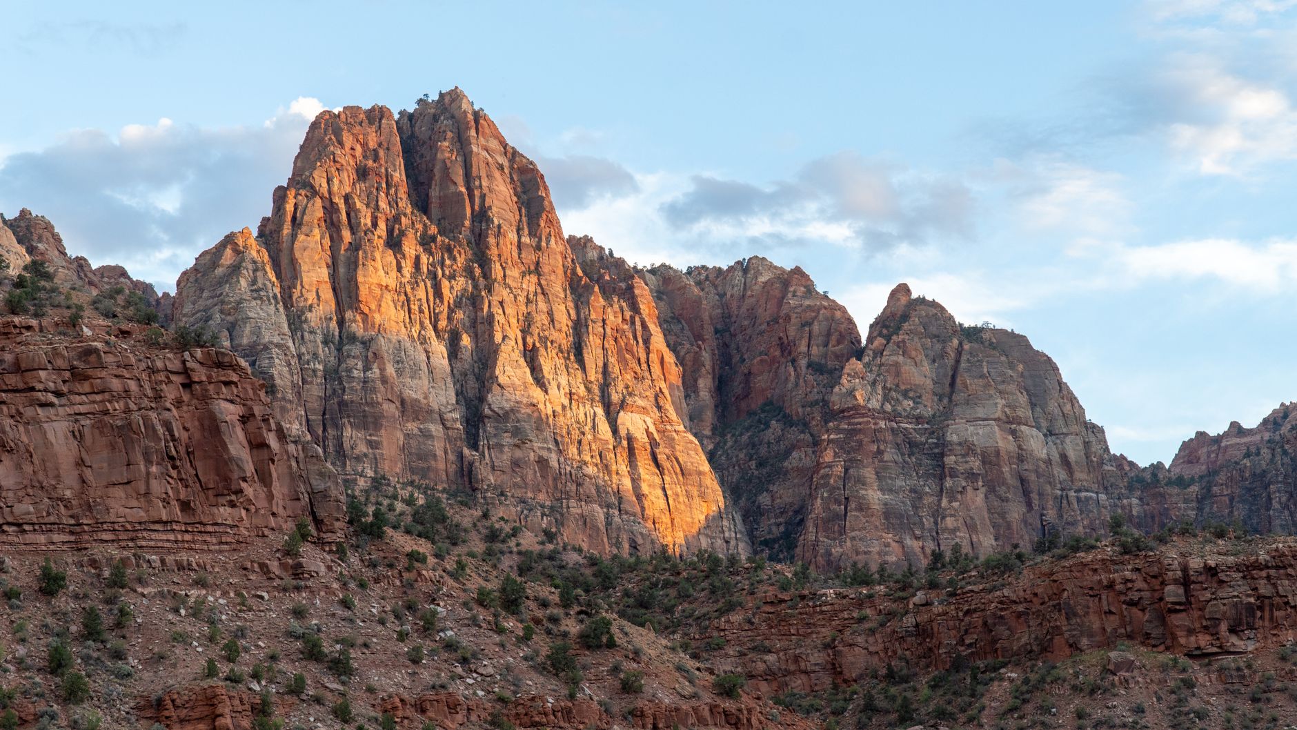 Sunset over rugged desert canyon with luxury tent lodge